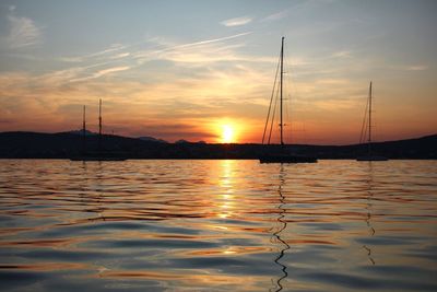 Sailboats in marina at sunset