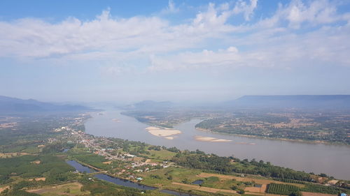 Aerial view of buildings in city against sky