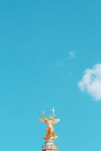 Low angle view of statue against blue sky