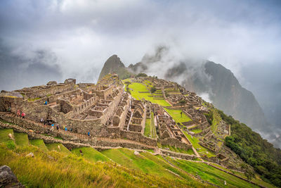 View of castle on mountain against cloudy sky