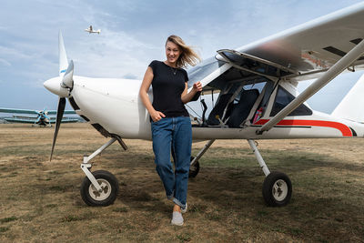 Girl near a small plane