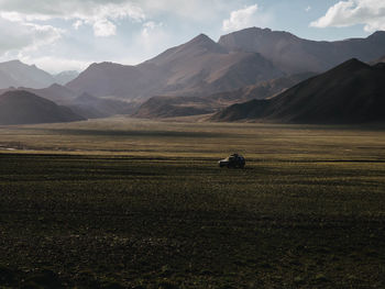 Land vehicle against mountain range