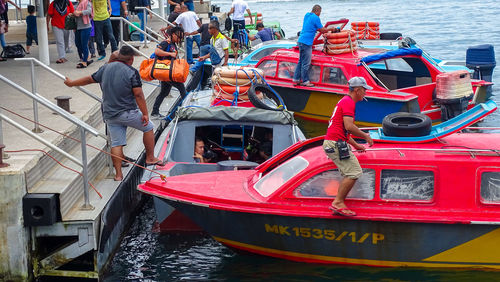 People working in boat moored in canal