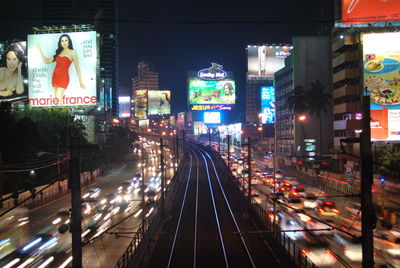 Railroad tracks in city at night
