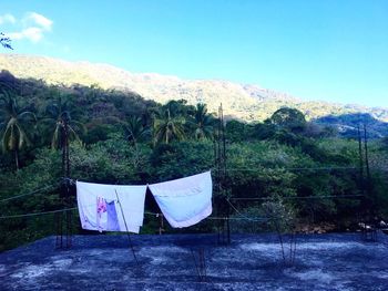 Clothes drying on clothesline against mountains