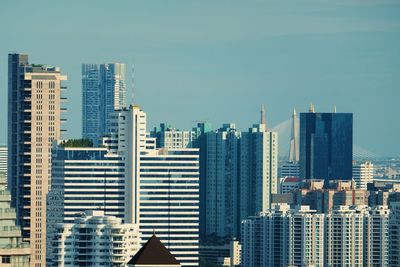 Modern buildings in city against clear sky