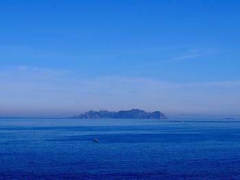 Scenic view of sea against blue sky