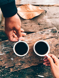 Cropped image of man holding coffee