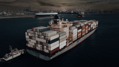 Photographs of container ships and tugboat floating at sea for the import and export 