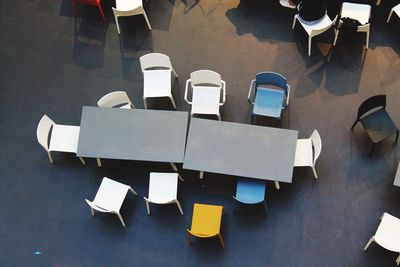 High angle view of empty chairs and table at cafe