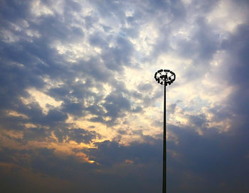 Low angle view of street light against cloudy sky