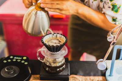 Cropped hand of person preparing coffee