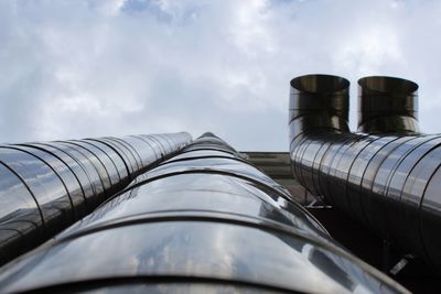 Low angle view of industry against sky