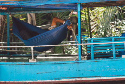 Man relaxing on hammock in boat