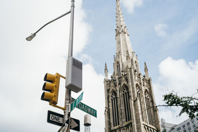 Low angle view of road sign against sky