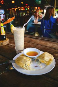 Woman eating food in restaurant