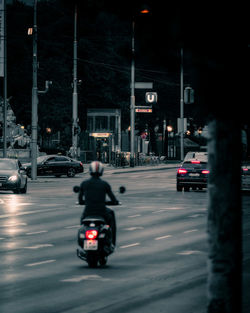 Vehicles on road in city at night