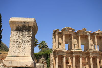 Low angle view of historical building against clear blue sky at ephesus in turkey