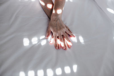 Cropped image of man hands on bed