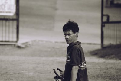 Side view of boy standing on street