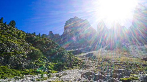 Scenic view of rocks against sky on sunny day