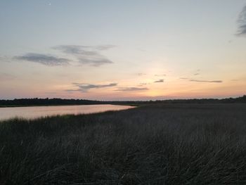 Scenic view of field against sky during sunset