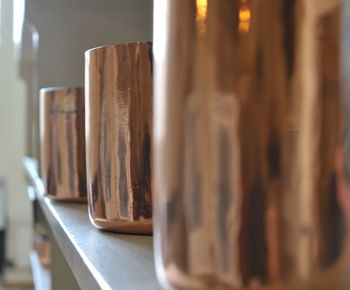 Copper pots on a shelf in a grand kitchen 