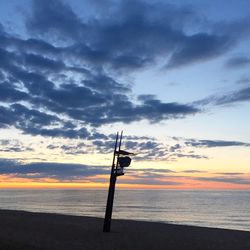 Silhouette of beach against sky during sunset