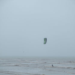 Person kite surfing at beach