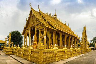 Statue of temple against cloudy sky