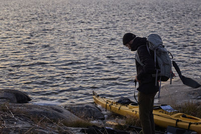 View of backpacker standing at sea