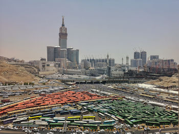 Aerial view of buildings in city against clear sky