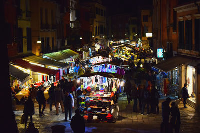 People at market in city at night