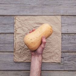 Cropped hand of person holding pumpkin