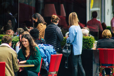 Rear view of people sitting in market