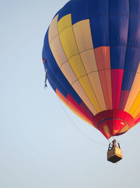 Low angle view of colorful hot air balloon flying against sky