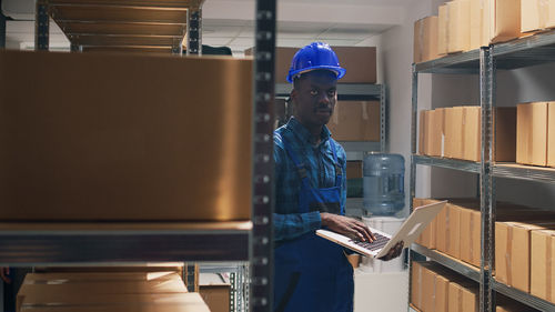 Rear view of man standing in factory