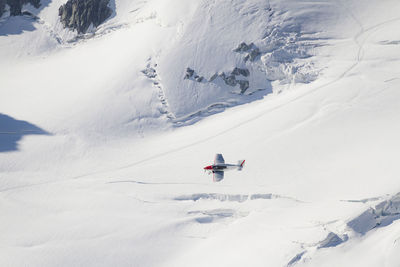 People skiing on snow covered land