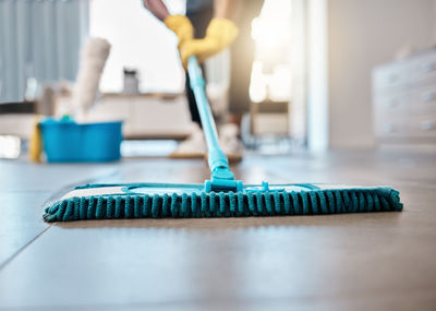 Midsection of man cleaning equipment