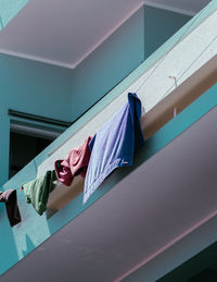 Low section of woman hanging on ceiling at home