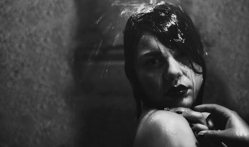 Close-up portrait of young woman taking shower