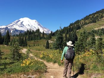 Rear view of man on mountain against sky