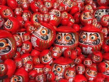 Full frame shot of red daruma dolls for sale at market