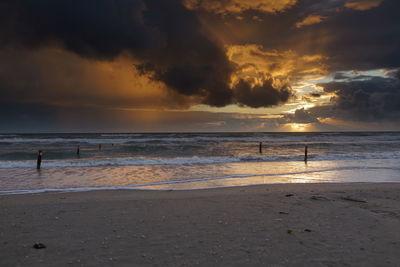Scenic view of beach against sky during sunset