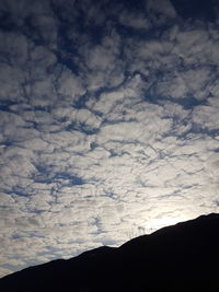 Low angle view of silhouette mountain against sky