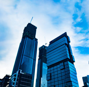 Low angle view of modern building against blue sky