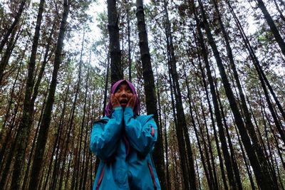 Portrait of woman standing in forest