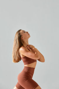 Young woman standing against white background