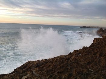 Scenic view of sea against dramatic sky