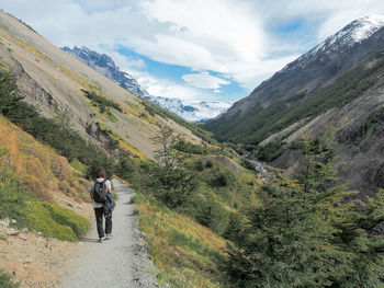 Rear view of man on mountain against sky